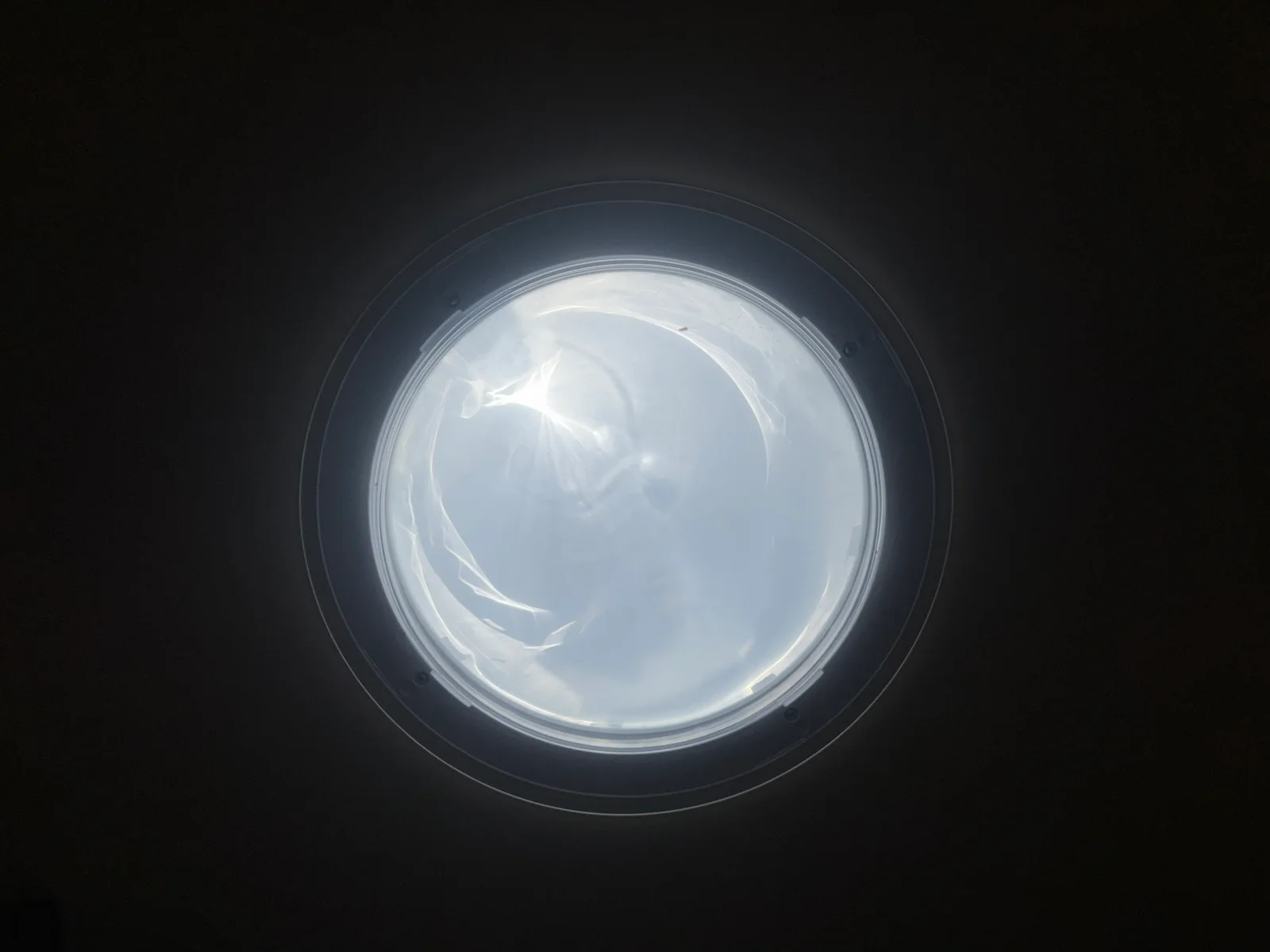 A circular light detail against a dark background