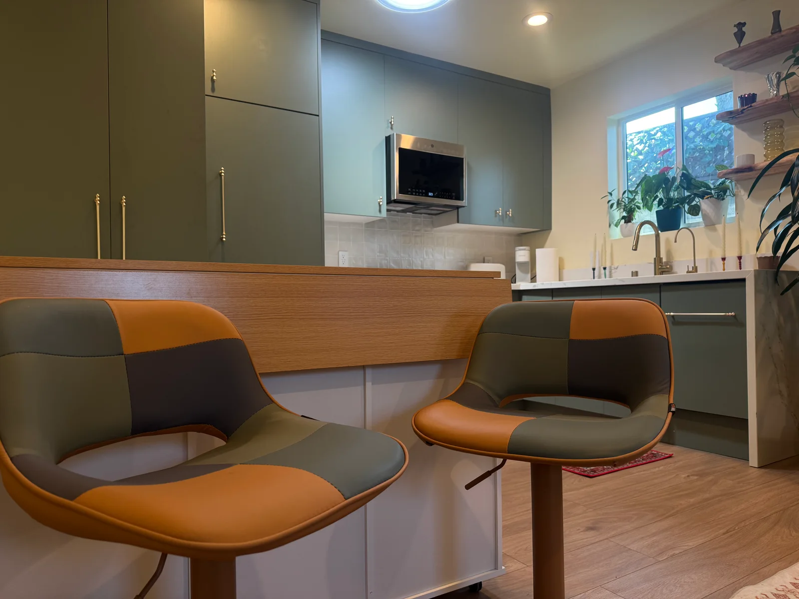 Two upholstered stools beside the kitchen counter