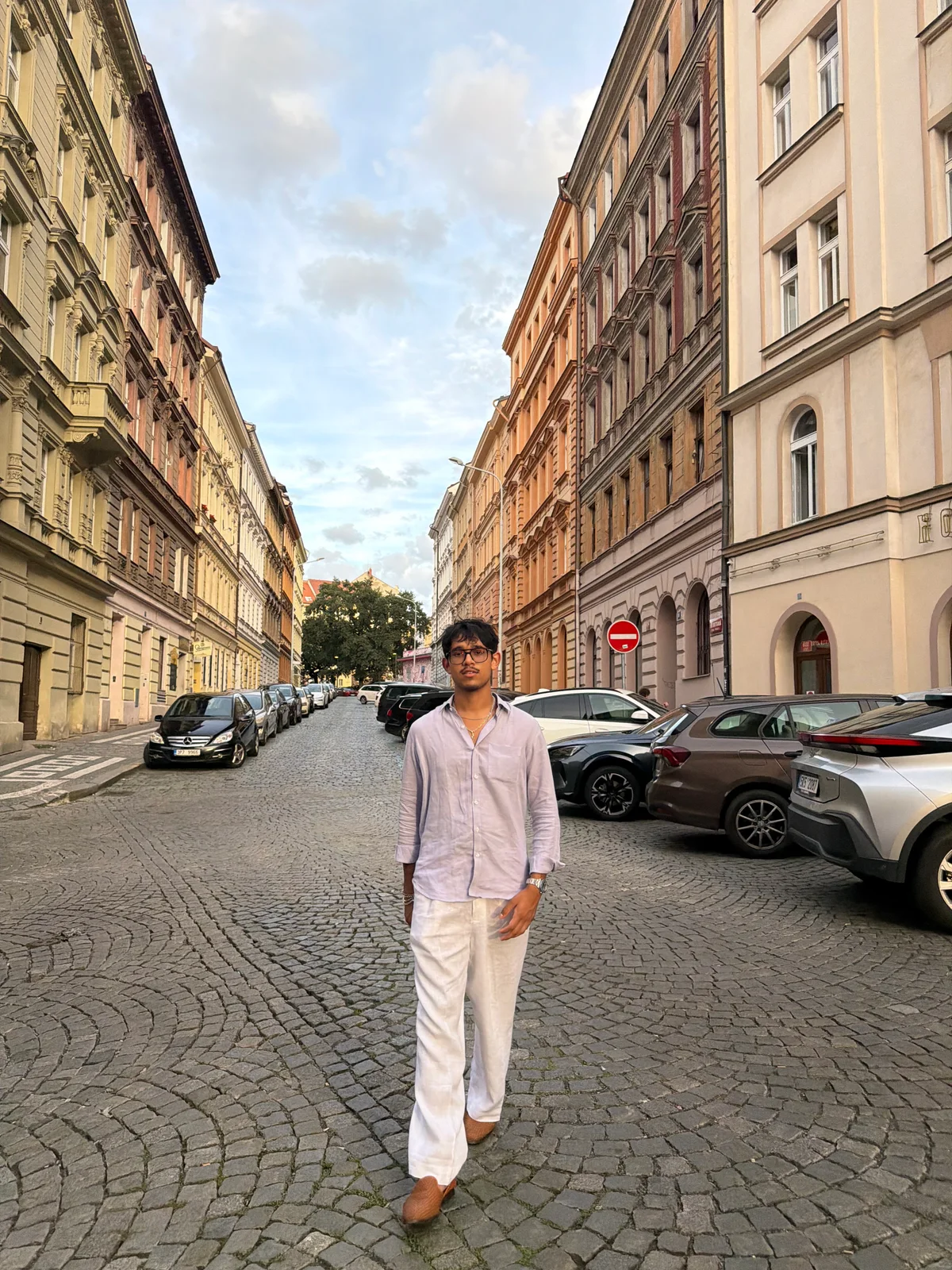Nabeel Thotti walking along a cobbled street in Czechia