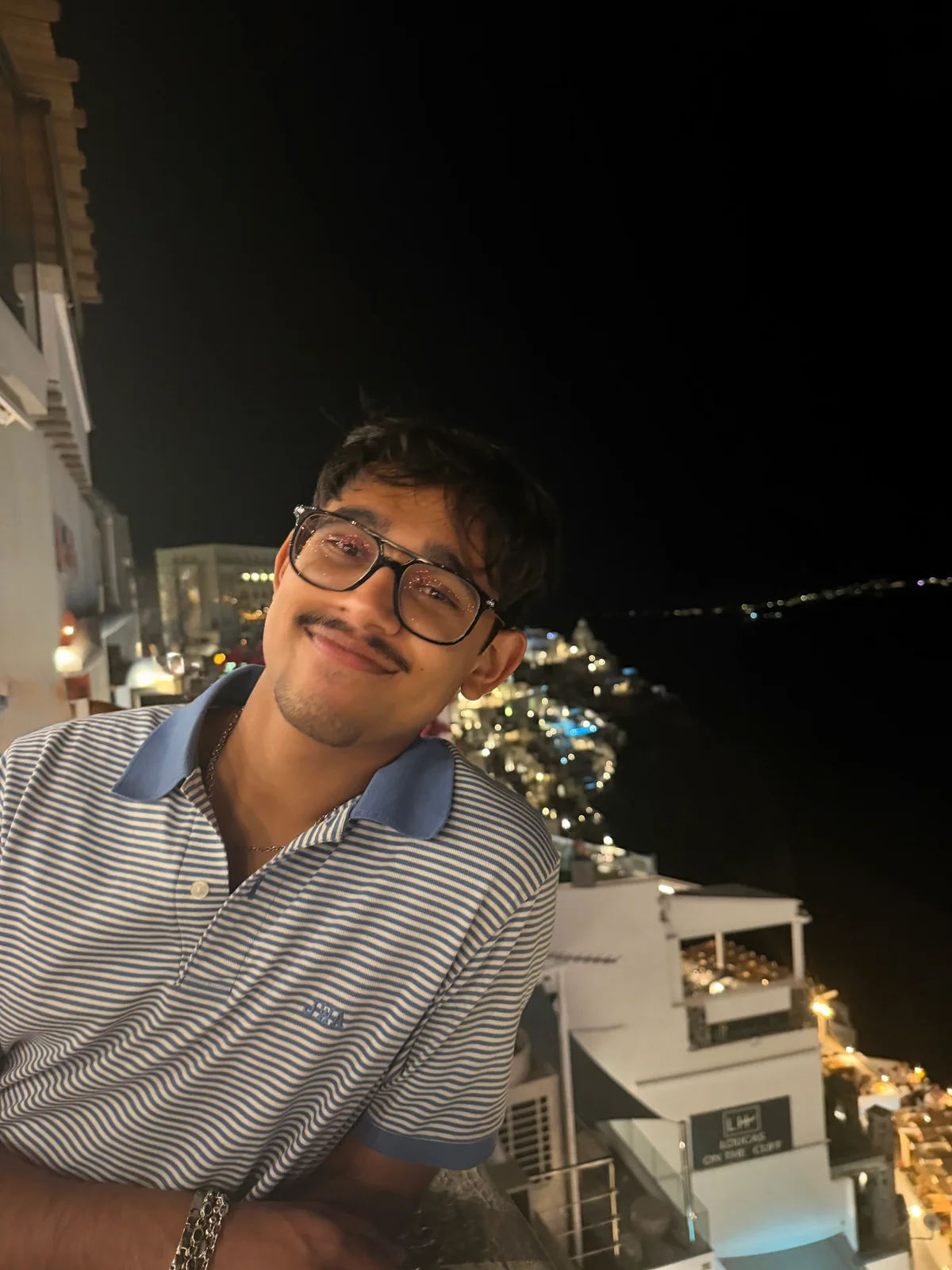 Nabeel Thotti overlooking the coast at night in Greece