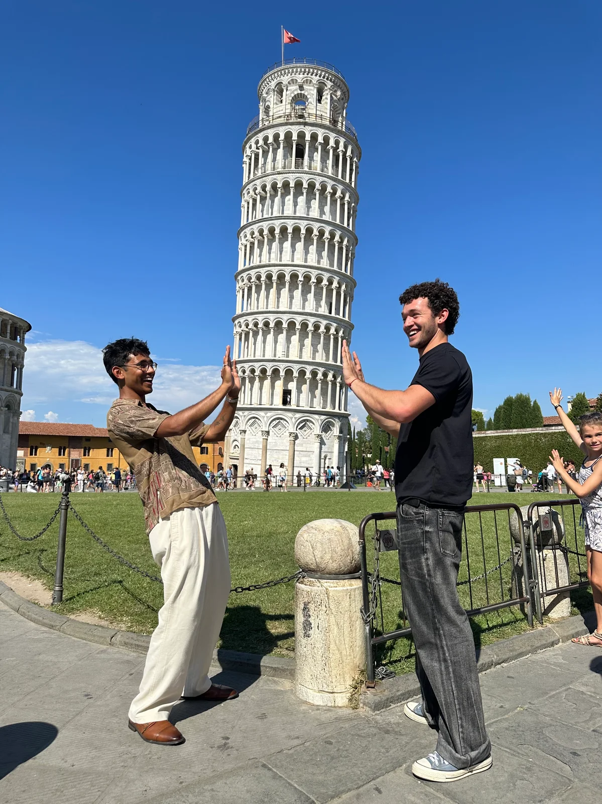 Nabeel Thotti and a friend posing beside the Leaning Tower of Pisa in Italy