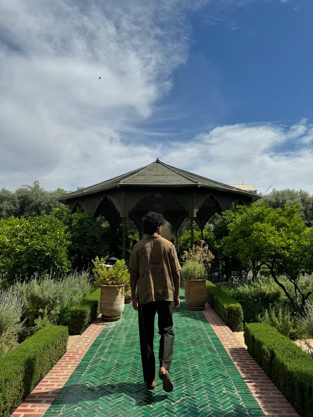 Nabeel Thotti walking through a garden in Morocco